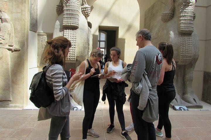 A family with teens enjoys a Private Louvre Teens Tour.