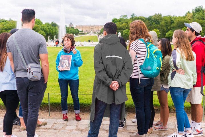 A guide tells a story, while leading a Versailles Bike Tour With Palace Timed Entry Ticket & Marie Antoinette’s Domain.