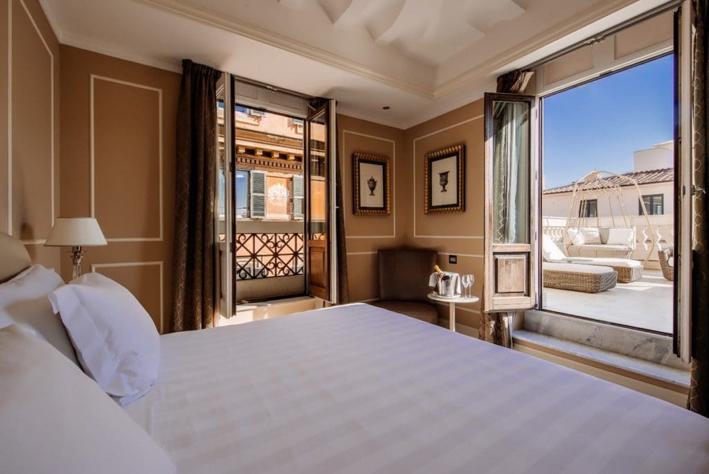 Inside one of the guest rooms at Aleph Rome Hotel, Curio Collection by Hilton, with a view of the city.