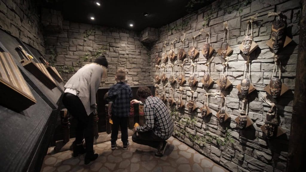 A family of three tries to conquer an escape room at Escape! Whistler, one of the best things to do in Whistler with kids this summer.