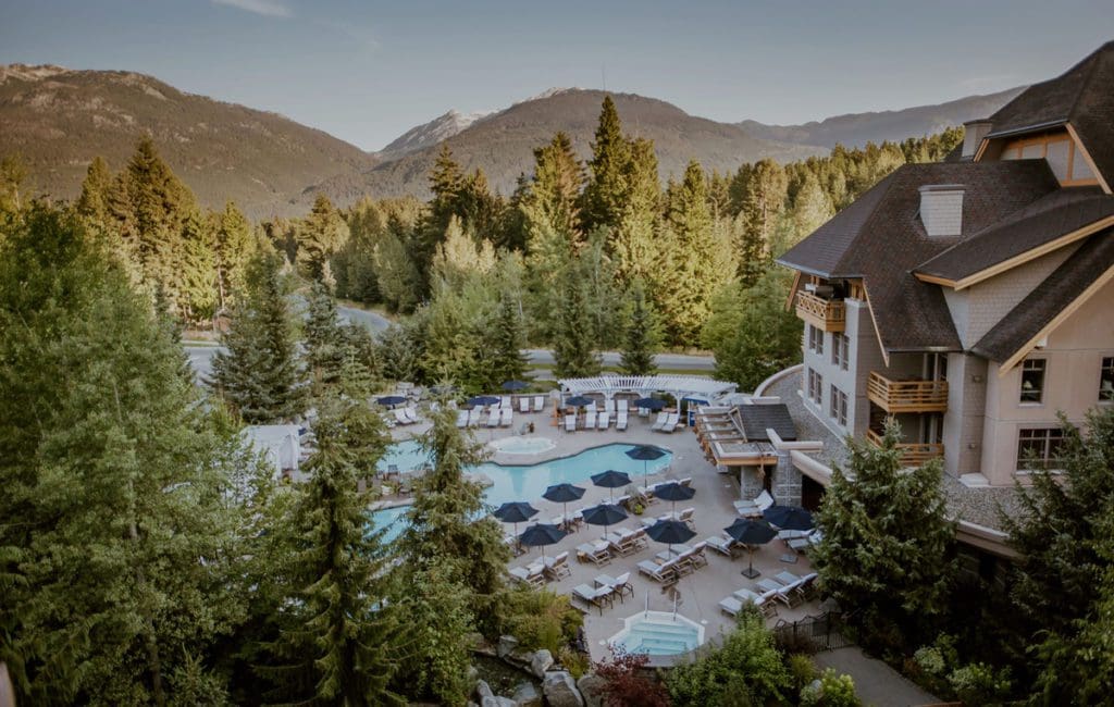 An aerial view of the outdoor pool and grounds at Four Seasons Resort Whistler in the summer.