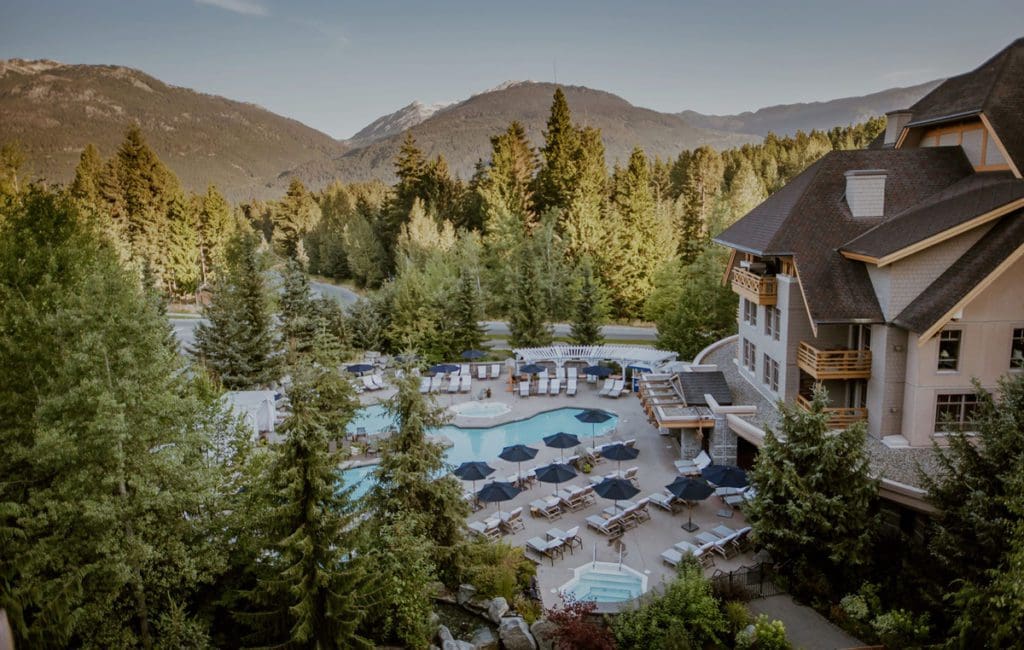 An aerial view of the outdoor pool and grounds at Four Seasons Resort Whistler in the summer.