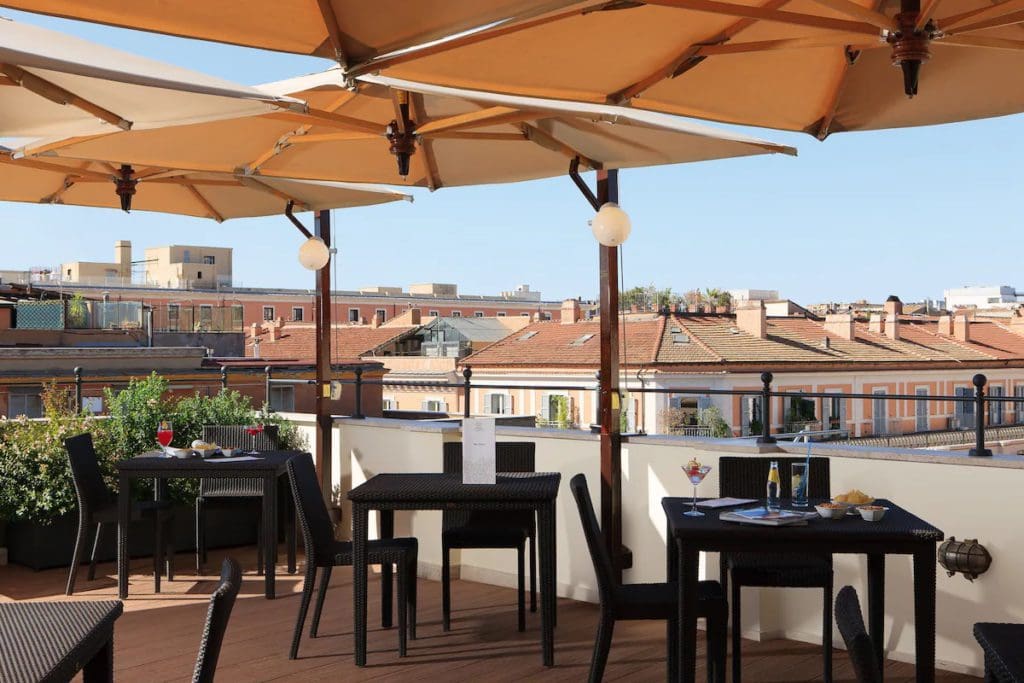 The outdoor terrace with a view of the city at Hotel Artemide, one of the best Rome hotels for families.