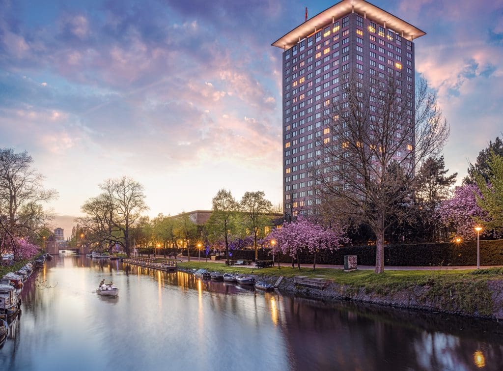 The exterior of Hotel Okura Amsterdam, along the canal.