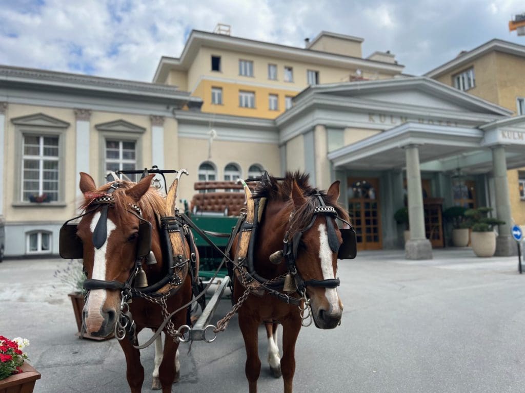 A horse-drawn wagon rests outside the entrance to Kulm Hotel.