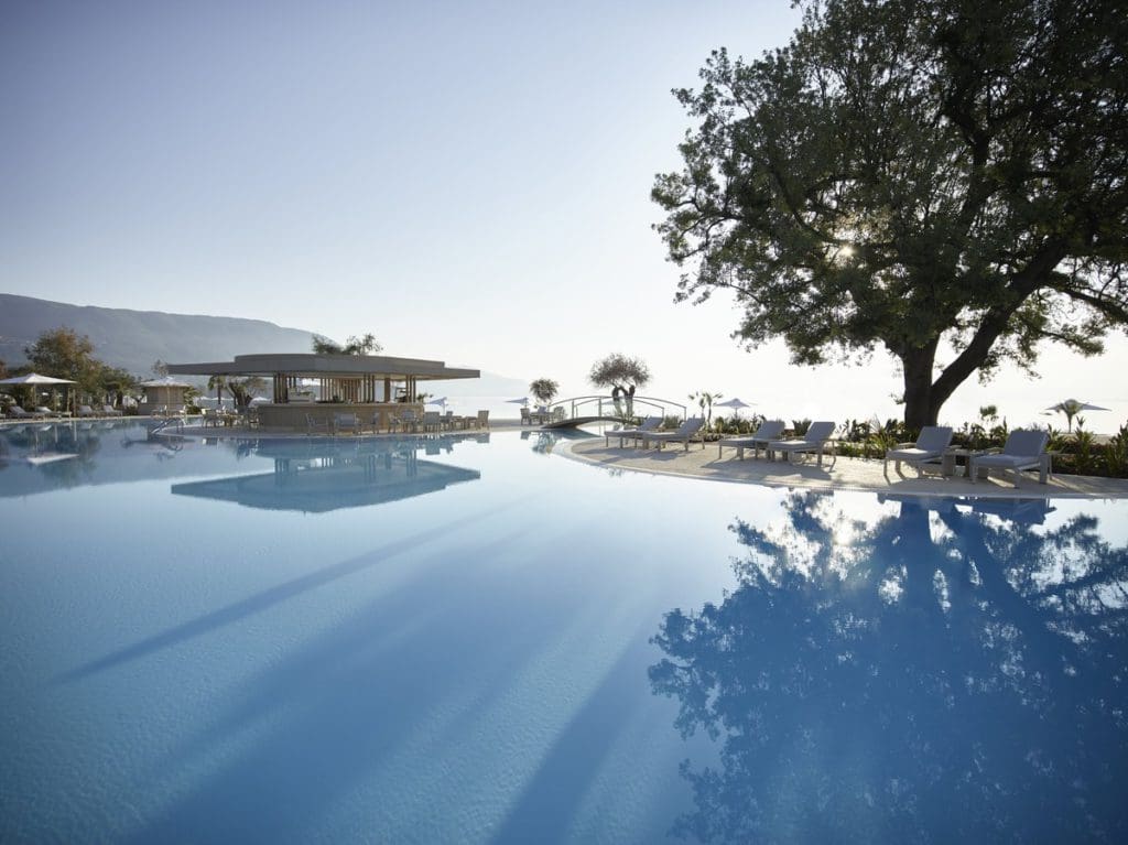 A view of the pool and surrounding pool deck at Ikos Dassia Resort, one of the best all-inclusive hotels in Greece for families.