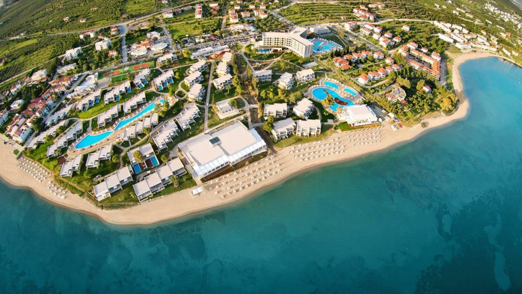 An aerial view of Ikos Olivia, along the beach in Greece, one of the best all-inclusive hotels in Greece for families.