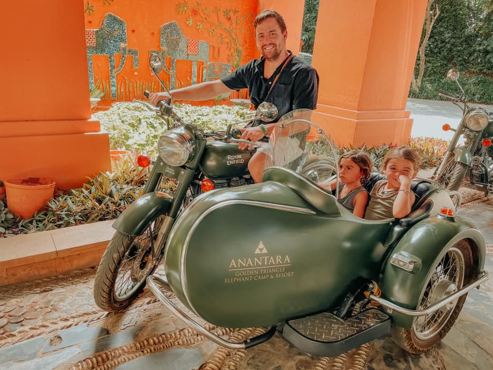 A dad and his two kids sit in a motorcycle with side car, preparing for a cruise around Phi Phi Island in Thailand.