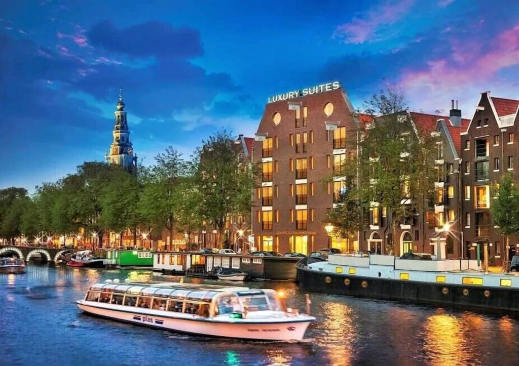 The exterior of Luxury Suites Amsterdam, along a canal.
