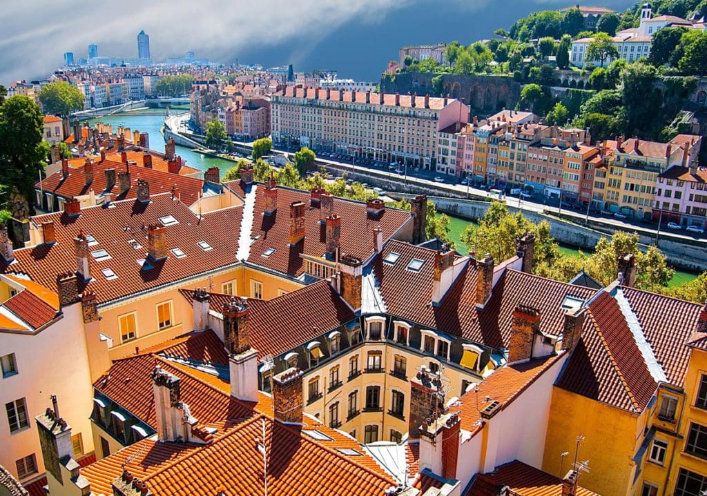 An aerial view of the iconic red roofs in Lyon, one of the best places to visit in France with kids.