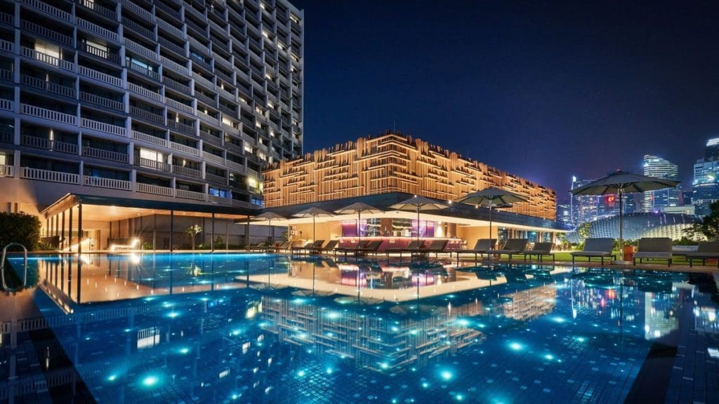 The large outdoor pool at PARKROYAL COLLECTION Marina Bay at night.