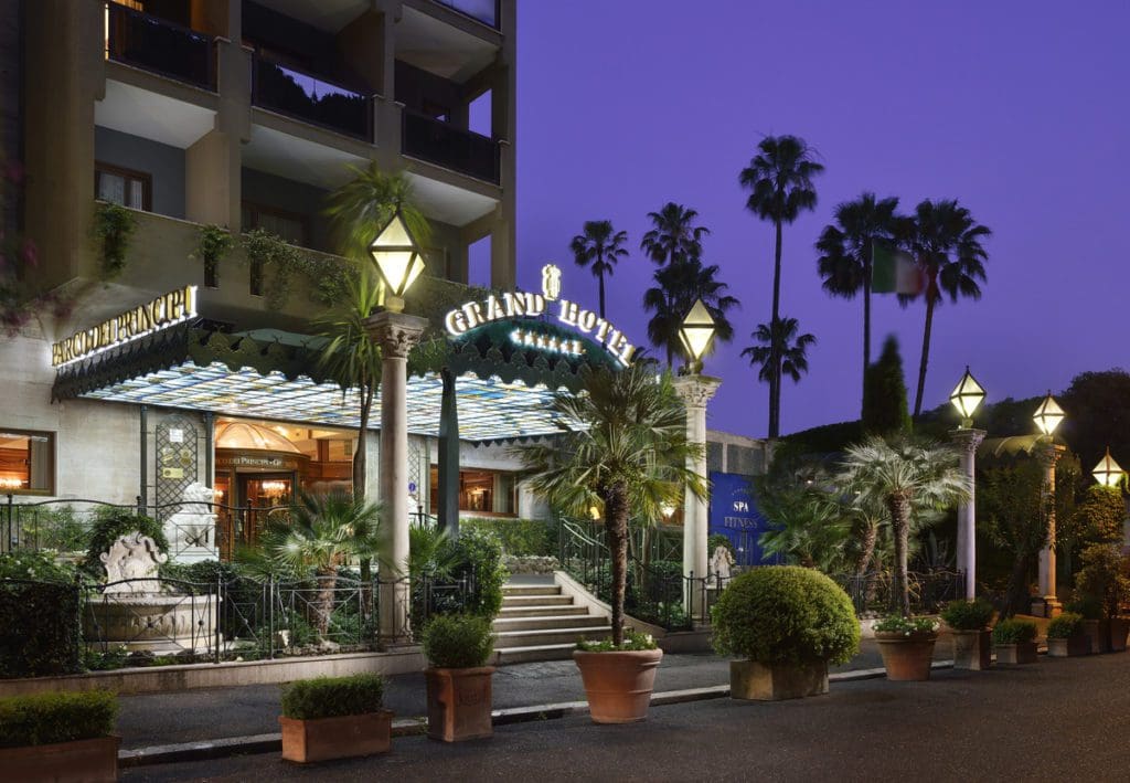 The exterior entrance to Parco dei Principi Grand Hotel & SPA, lit up at night.