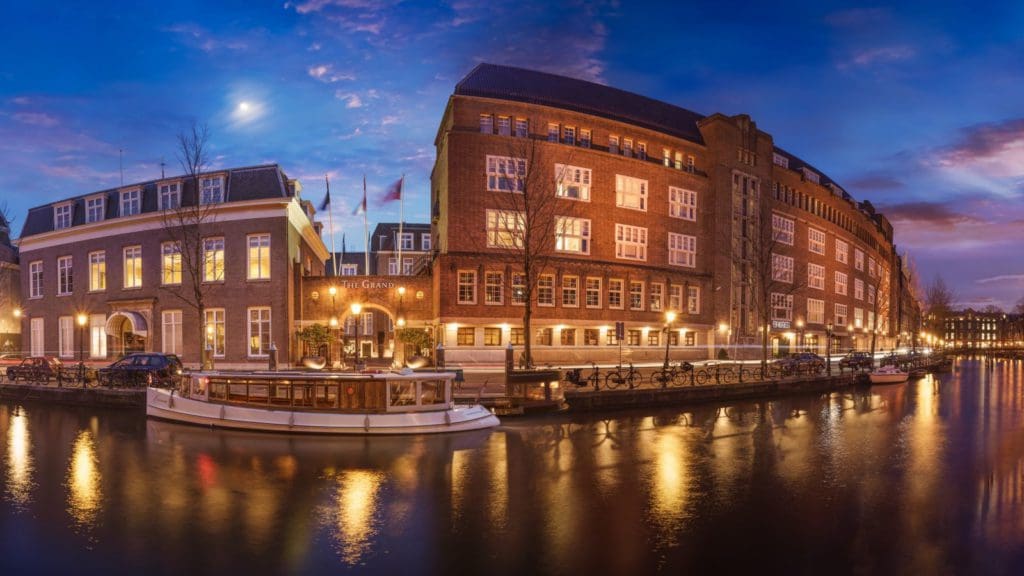 The exterior of Sofitel Legend the Grand Amsterdam, along a canal.