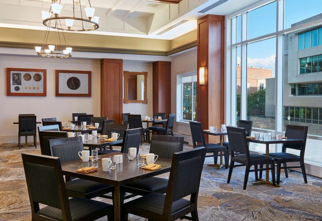 Tables set for breakfast at one of the on-site dining areas of The Inn at Penn, a Hilton Hotel.