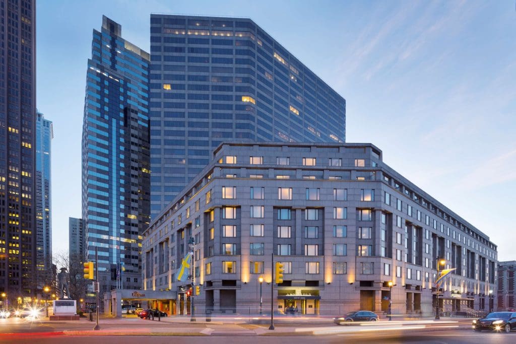 The exterior entrance to The Logan Philadelphia, Curio Collection by Hilton at dusk.