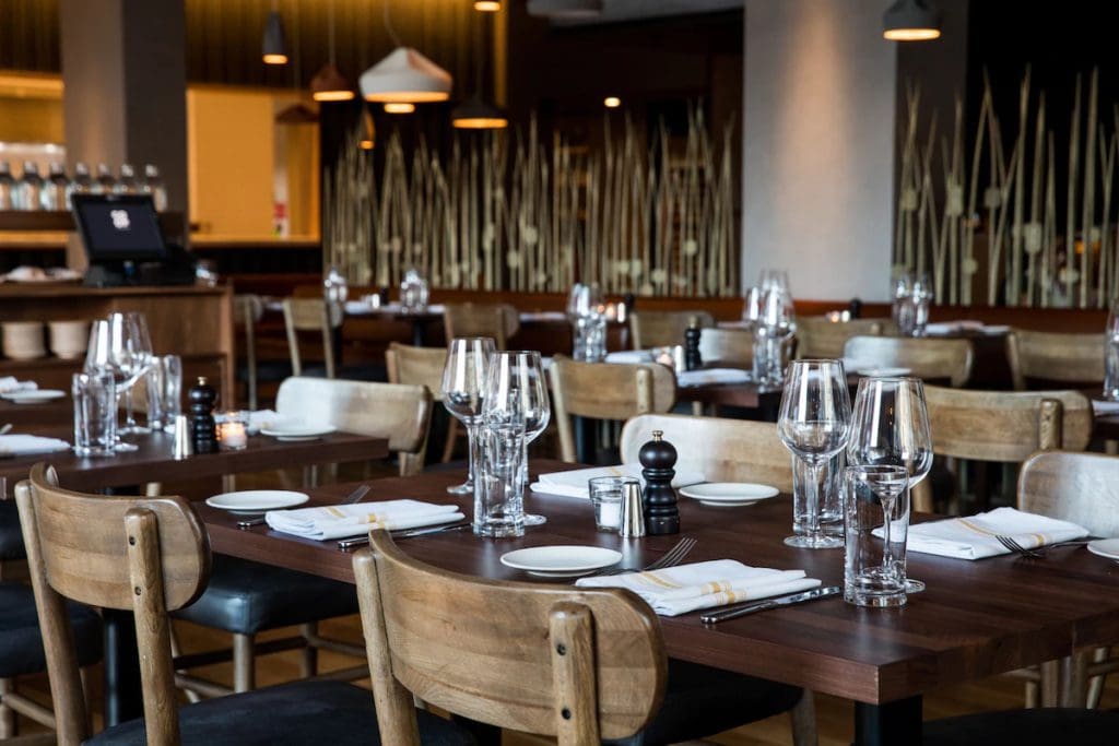 Tables set for dinner in the on-site restaurant at The Study at University City.