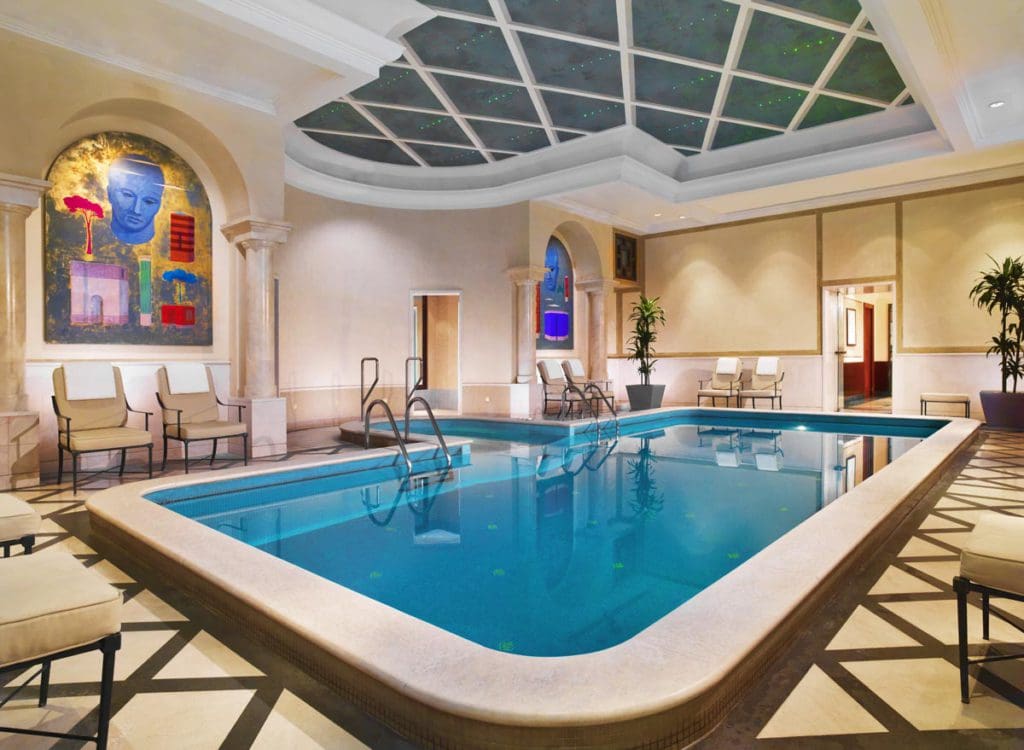 The indoor pool, with art on the walls, at The Westin Excelsior, Rome.