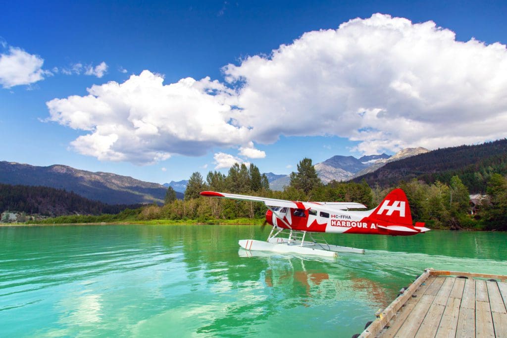 A floatplane rests on the water after a tour, one of the best things to do in Whistler with kids this summer.