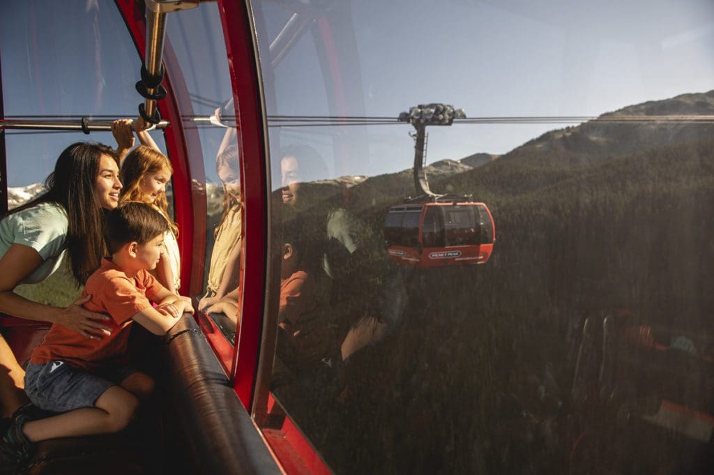 A family enjoying a ride on the Peak 2 Peak Gondola, one of the best things to do in Whistler with kids this summer.