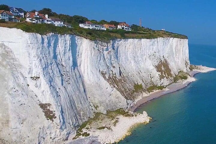 The white cliffs of Dover along the water's edge.