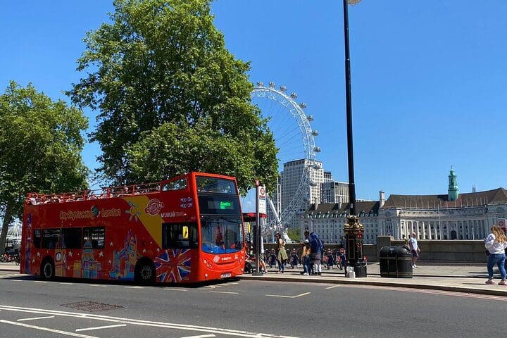 A Hop-on, Hop-off bus picks up new passengers outside the London Eye.