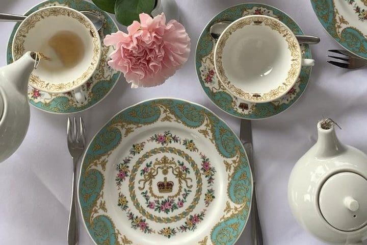 An overhead view of a teapot pouring tea at a High Tea experience in Kensington Gardens.