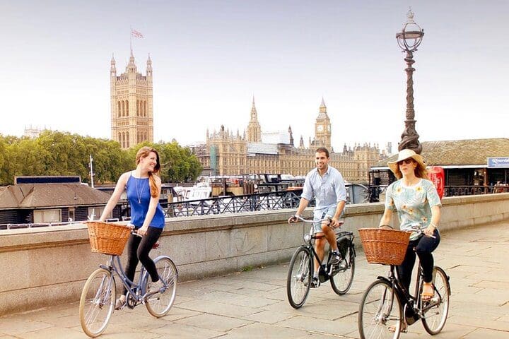 Three people take a bike tour of London,one of the best experiences in London with kids. 