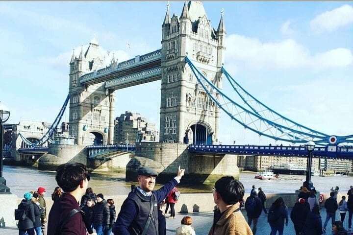 A tour guide points to the Tower of London during a private city tour, one of the best experiences in London with kids. 