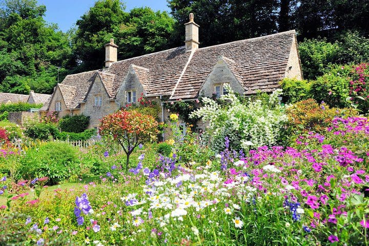 A lovely cottage nestled in flowers in the Cotswolds, one of the best experiences near London with kids. 