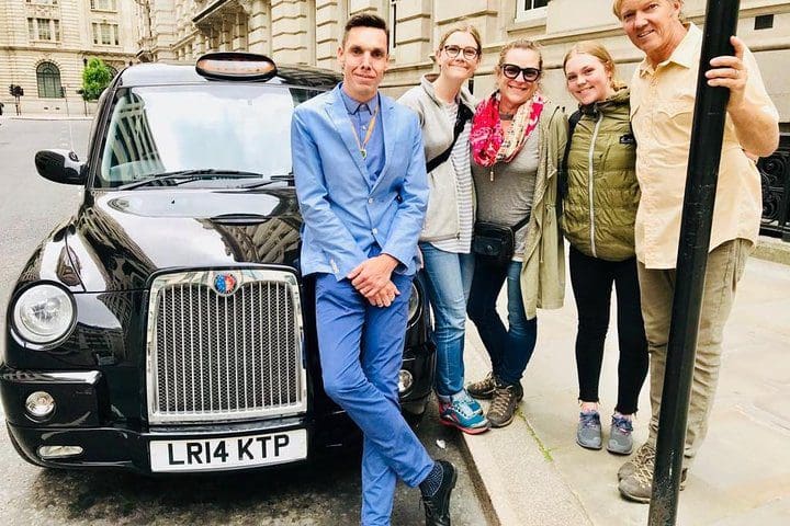 A family stands with a London tour guide during a private tour of the city, one of the best experiences in London with kids. 