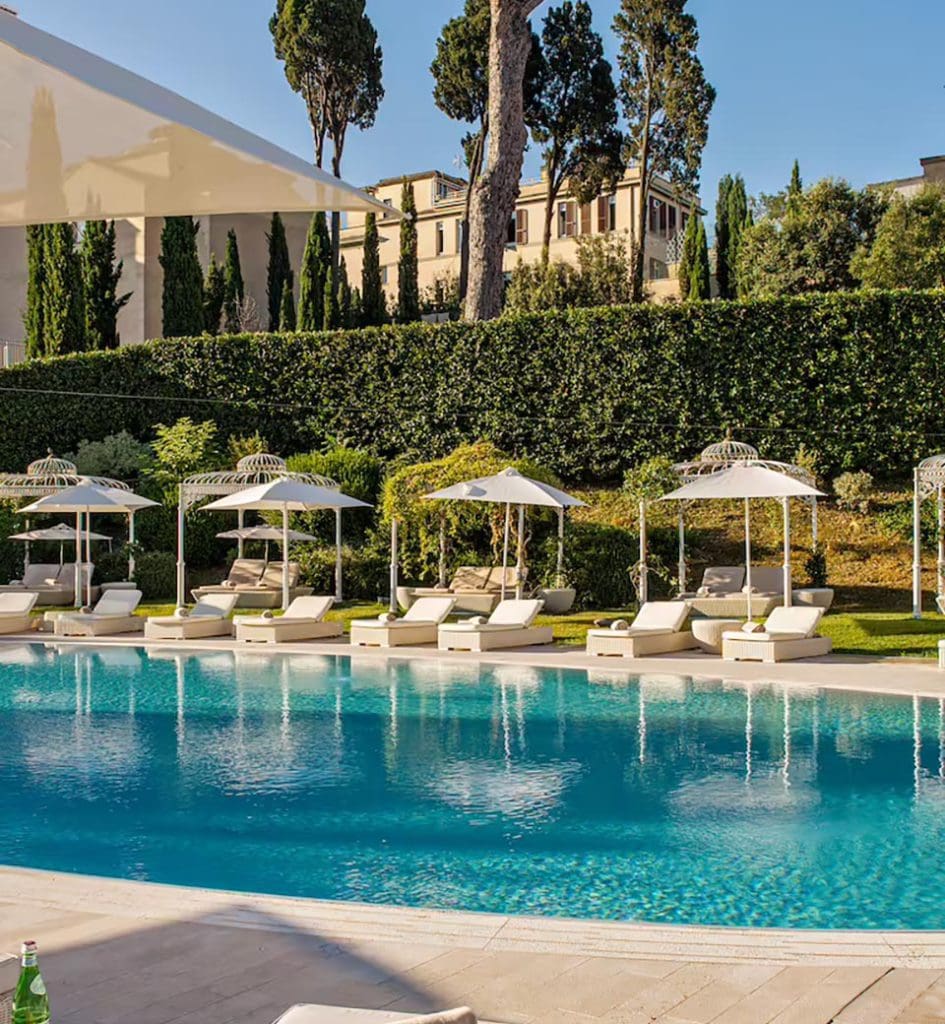 The outdoor pool and nearby pool loungers at Villa Agrippina Gran Meliá.