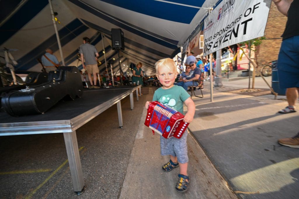 A small boy plays a small accordion during Polkafest at New Glarus.