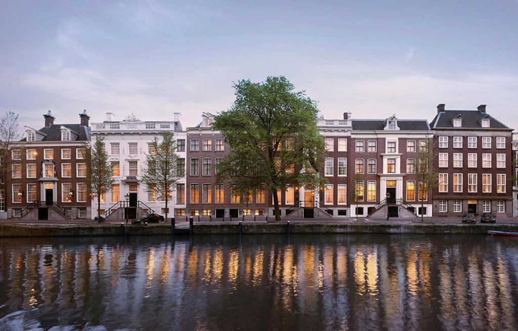 The exterior entrance to Waldorf Astoria Amsterdam, along the canal.