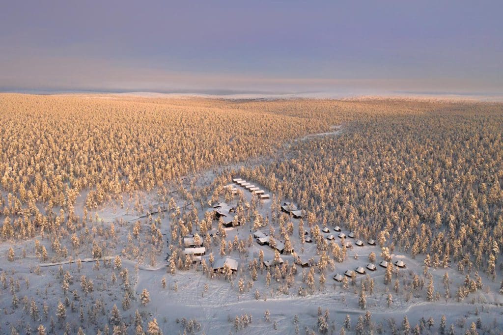 A wintery aerial view of Wilderness Hotel Muotka, one of the best Finland hotels for families.