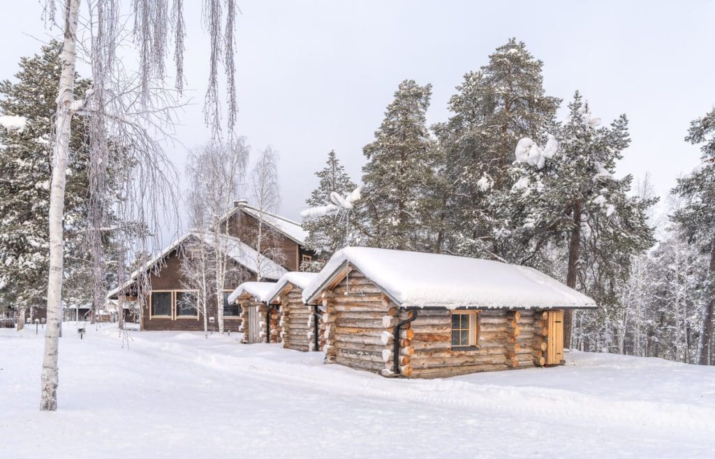 One of the cabins at Wilderness Hotel Nellim in the snow at one of the best Finland hotels for families.
