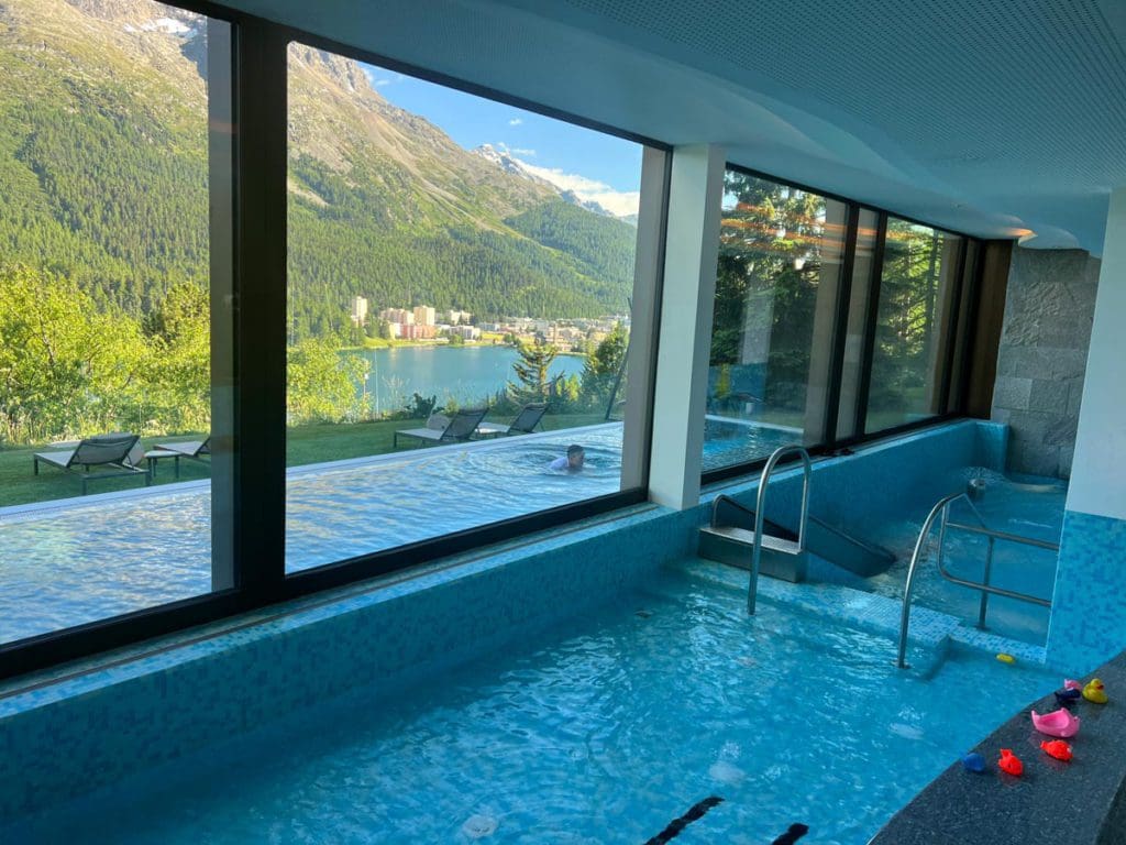 The indoor pool at Kulm Hotel, looking out onto the outdoor pool.