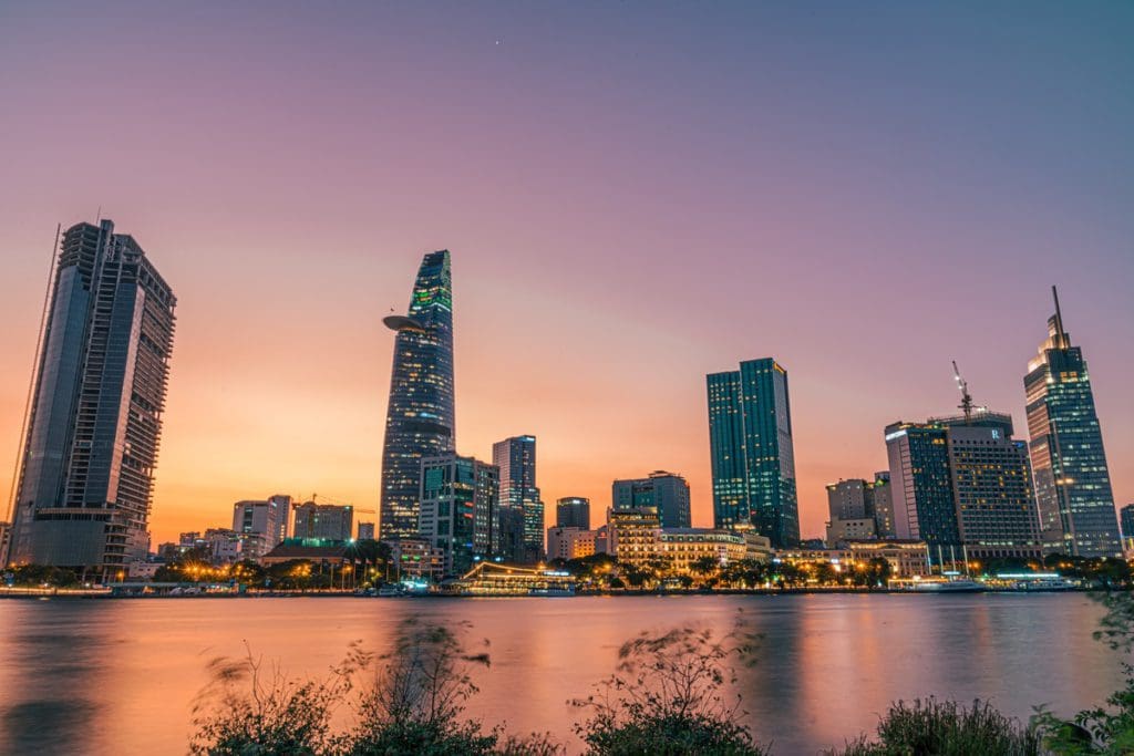 The city skyline of Ho Chi Minh City in Vietnam at sunset.