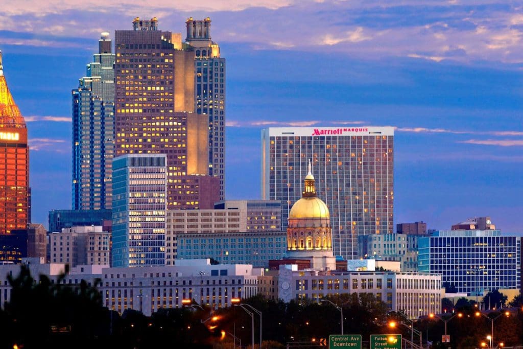 The exterior of Atlanta Marriott Marquis on the Atlanta sky line at dusk, one of the best hotels in Atlanta for families.