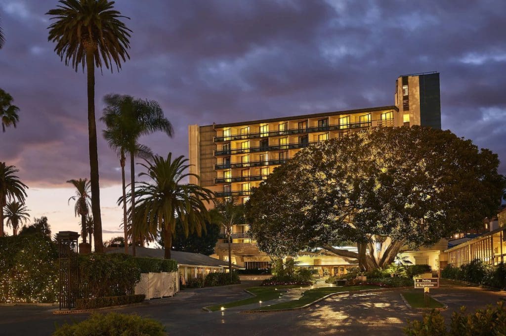 The exterior of Fairmont Miramar - Hotel & Bungalows at dusk.