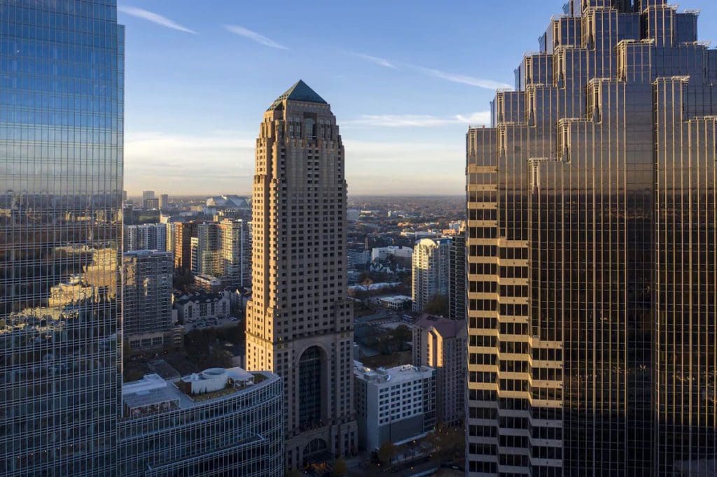 The exterior of  Four Seasons Hotel Atlanta along the Atlanta skyline, one of the best hotels in Atlanta for families.