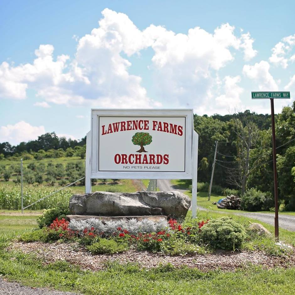 The entrance sign to Lawrence Farm Orchards, one of the best places to go apple picking near NYC with kids.