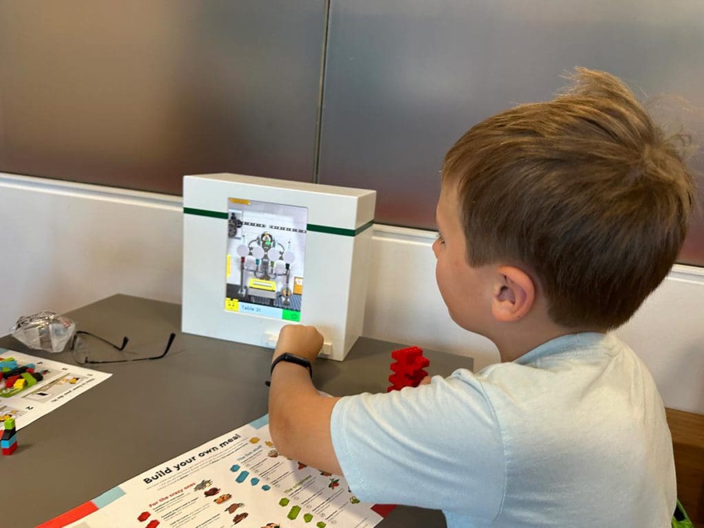 A young boy enjoys a mini chef experience at LEGOLAND® Billund Resort.