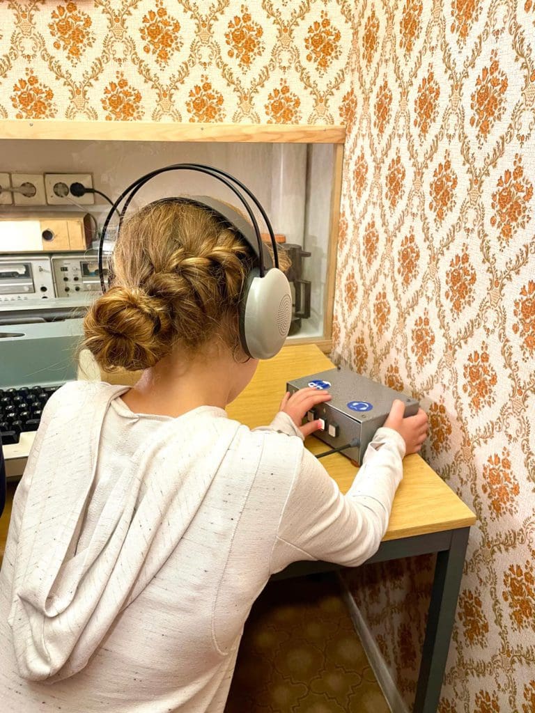 A young girl interacts with an exhibit at the DDR Museum.