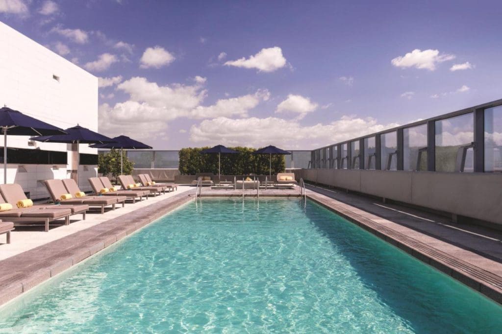 The outdoor pool and surrounding pool deck at The Ritz-Carlton, Los Angeles.