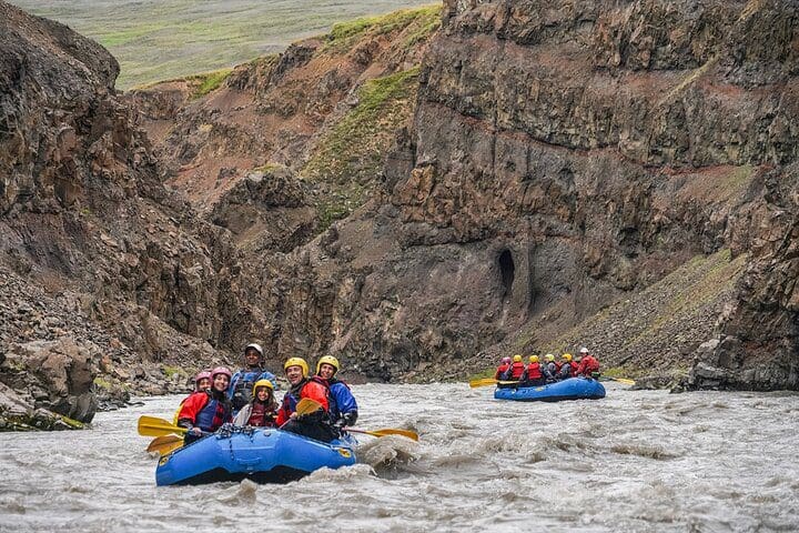 Two rafts move down river on the Family Rafting Day Trip from Hafgrímsstaðir: Grade 2 White Water Rafting on the West Glacial River, one of the best Iceland tours with kids.
