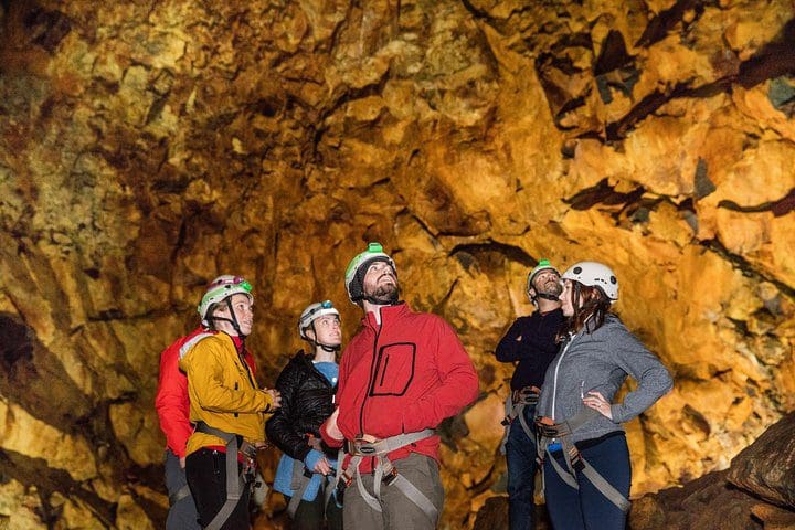 A group of people stands inside a volcano, while on the Inside the Volcano: Small Group Thrihnukagigur Hike and Tour from Reykjavik.