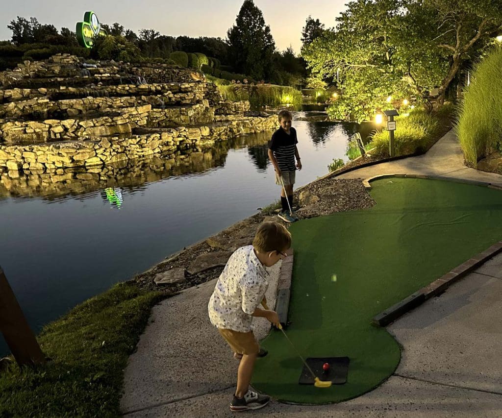 Two boys play golf at Nemacolin.