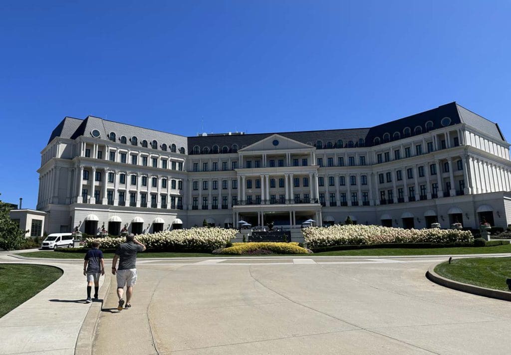 Two boys walk toward the entrance to Nemacolin Resort, a family resort in Pennsylvania your family will love.