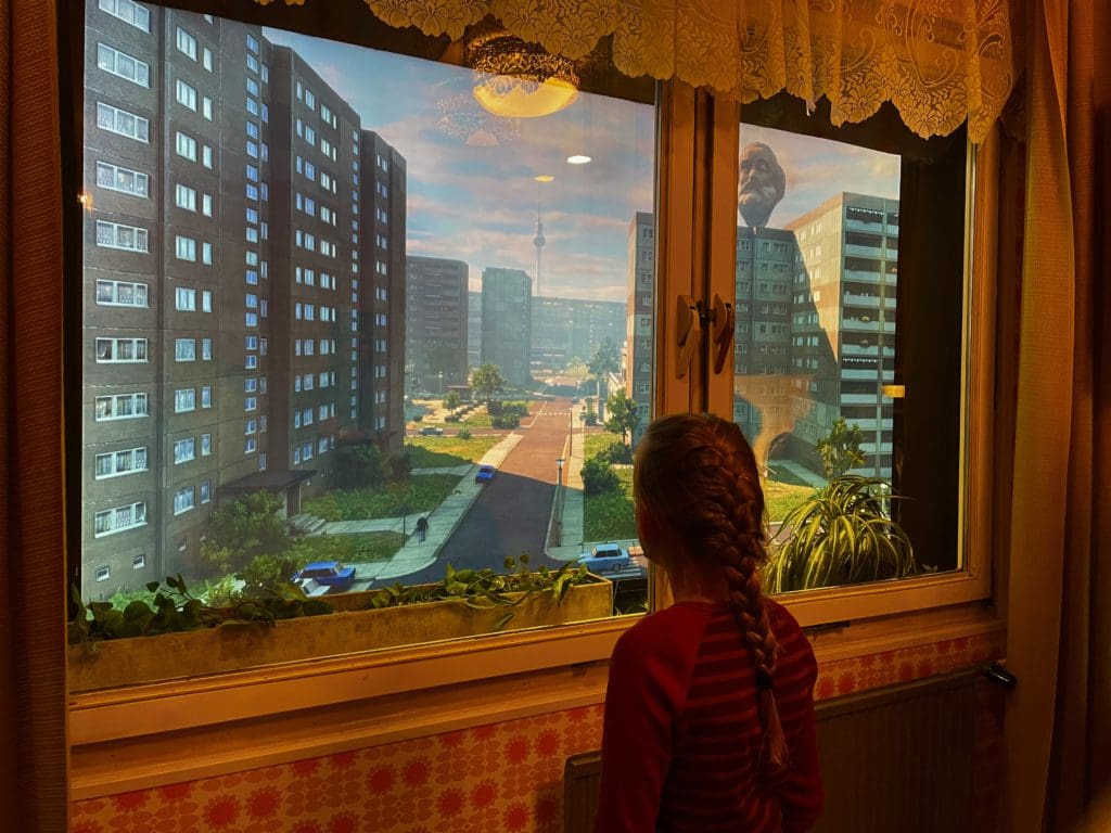 A young girl studies a display at the DDR Museum, a great idea when planning a Berlin itinerary with kids.