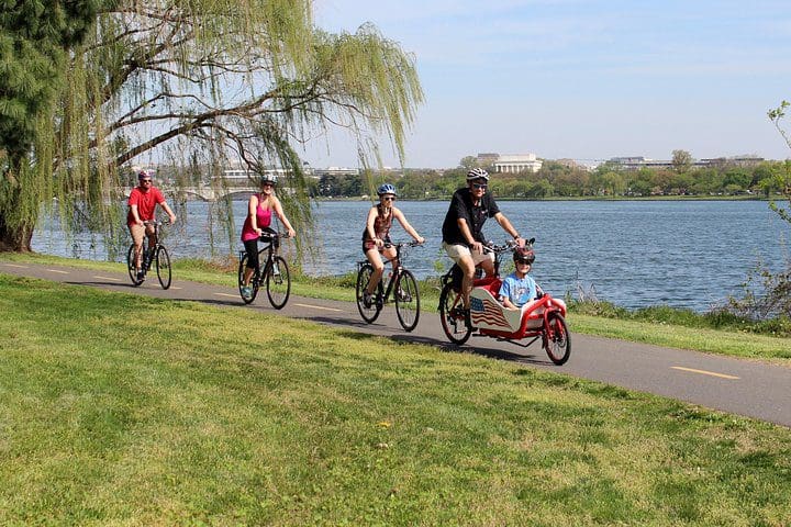 A family bikes along the river in Washington DC on the Private Family-Friendly DC Tour by Bike.